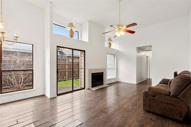 Cozy fireplace and tall ceilings within the living