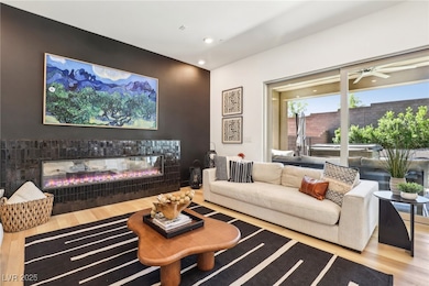 Living room featuring wood finished floors, a glas