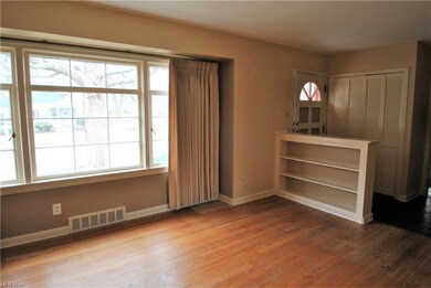 Another view of living room shows display shelves.