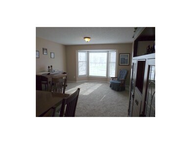 Formal living room/dining room offers bay windows,