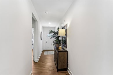 Hallway with dark hardwood / wood-style floors