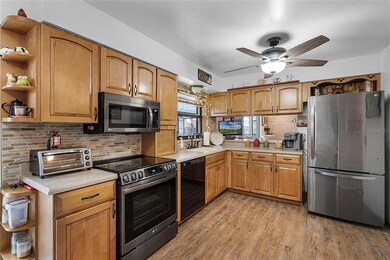 The kitchen includes stainless steel appliances.