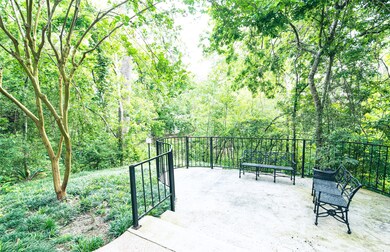 Serene Outdoor Space by the Bayou.
As you walk around the building to the entrance of the condo, you'll be greeted by a beautiful, tranquil corner space overlooking the bayou. This serene outdoor area is the perfect spot to sit and enjoy the lush, natural landscape. Surrounded by mature trees and vibrant greenery, it offers a peaceful retreat in the heart of nature, making it an ideal place to relax or unwind.