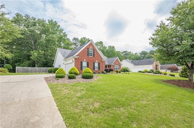 View of front of house featuring brick siding, concrete driveway, and a garage