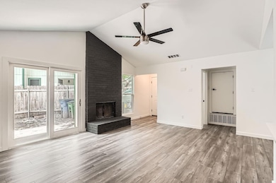 Unfurnished living room featuring a ceiling fan, 