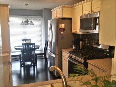 Kitchen features updated floors, Corian top and ti