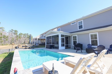 View of pool with a patio area, a fenced in pool, a fenced backyard, and a sunroom