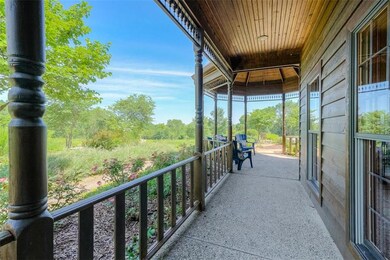 Wrap around porch on a treed lot with surrounding 