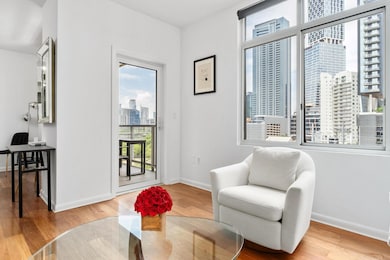 Living area featuring a view of city, a desk, and