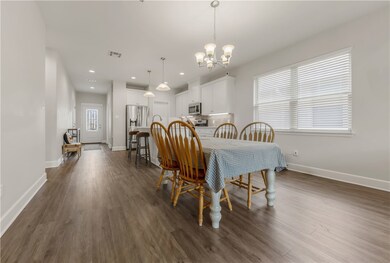 Dining space featuring a chandelier, dark wood-typ