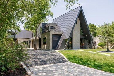 A-frame style home with a front lawn, metal roof,