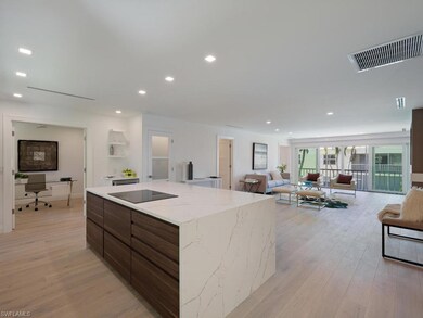 THe open island kitchen features a lighted pantry 
