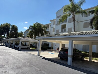 View of building exterior featuring covered parking