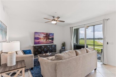 Living room featuring ceiling fan and light tile f
