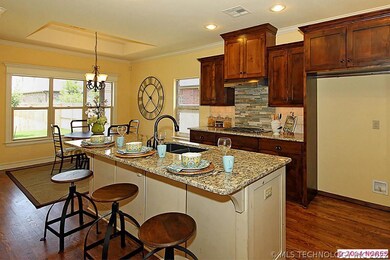 Granite island kitchen with alder cabinets.
