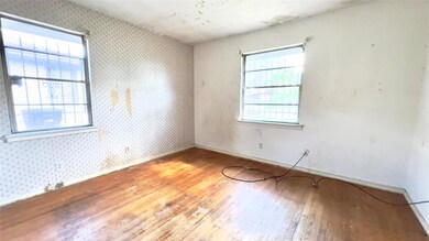 Spare room featuring wood-type flooring and a heal