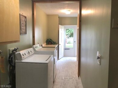 Laundry room is off the kitchen and has garage ent