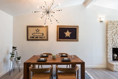 Dining area with a chandelier and light wood fini