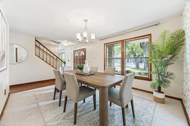 Dining room featuring a chandelier, stairway, and