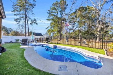 View of pool with a lawn