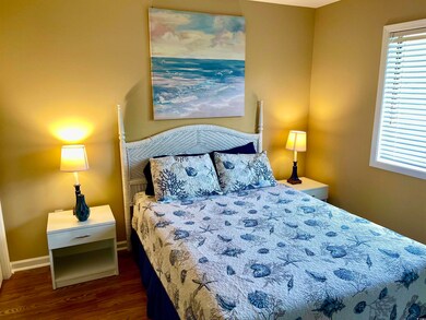 Bedroom with dark wood-type flooring