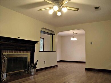 Living Room. Beautiful wood mantle surrounds log b