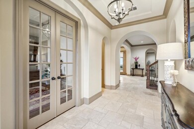 Hall featuring an inviting chandelier, ornamental 