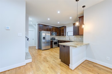 A chic tile backsplash enhances the modern aesthet