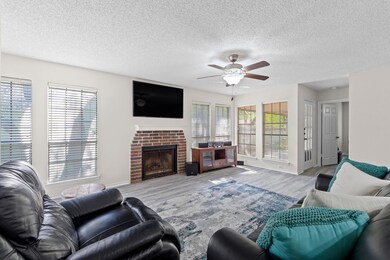 Living room featuring ceiling fan, wood finished 