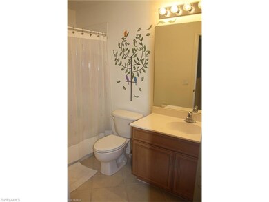 Bathroom featuring vanity, tile patterned flooring, and shower / bath combo with shower curtain