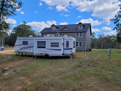 This camper sits next to the home.