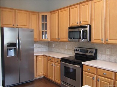 Kitchen with tile backsplash and stainless steel a