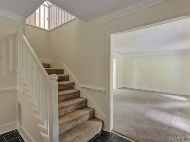 Carpeted stairway leads to the second floor and wi