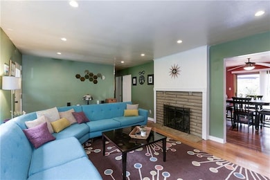 Inside, greet guests in a spacious living room with a center piece gas fireplace and original hardwood floors.