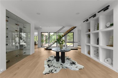 Corridor featuring stairs, wood finished floors, and built in features