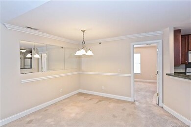 Dining Area with crown molding and updated light f