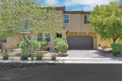 View of front facade featuring a garage, stucco si