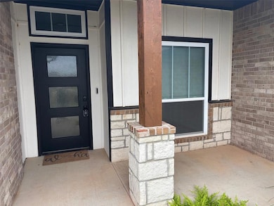 Entrance to property featuring board and batten siding and covered porch