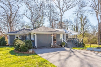 Ranch-style house with a shingled roof, a front la