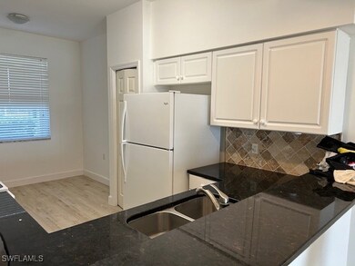 Kitchen with sink, light wood-type flooring, white
