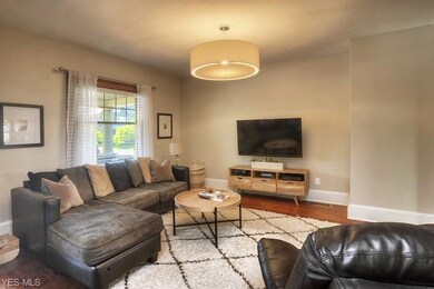 Warm hardwood flooring, large windows and updated lighting...