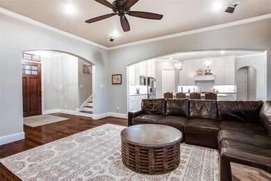 Open concept living with large archways to define 