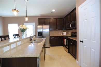 The long view of the kitchen and pantry area.