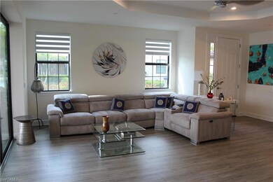 Living room featuring baseboards, ceiling fan, woo
