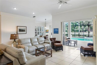 Tiled living room featuring ceiling fan and orname