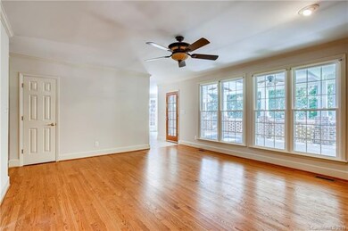 Hardwoods in the family room w/ a gas fireplace.  The wall of windows allows lovely views of the private backyard and covered patio area.