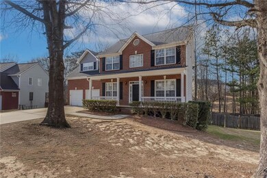 Colonial-style house with driveway, an attached ga