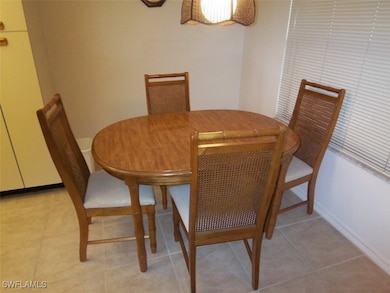 Dining space with light tile patterned floors and