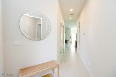 Corridor with light tile patterned flooring