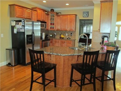 The kitchen includes: Granite Countertops, Disposal, Refrigerator, Built-in Microwave, Dishwasher, and Stove.